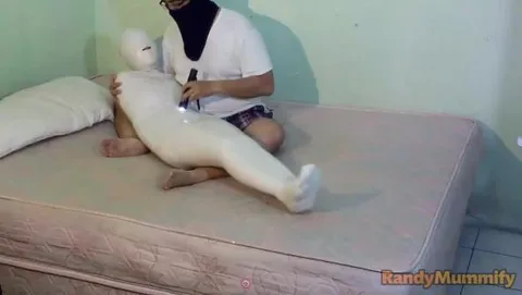 A beautiful girl is mummified and given electric shocks