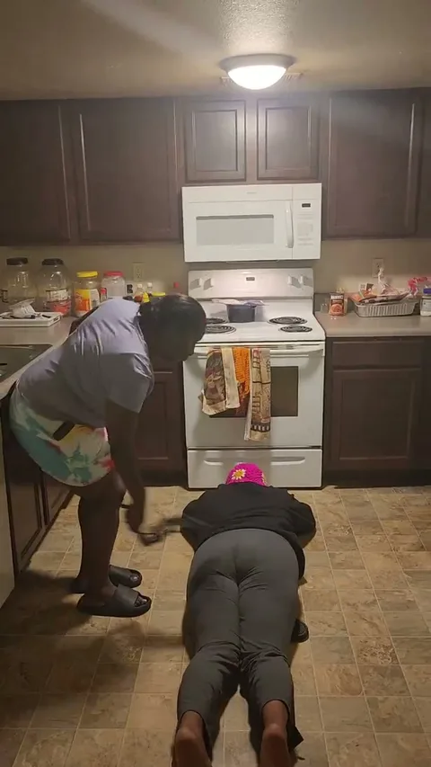 Kila gets spanked on dining room floor still 3