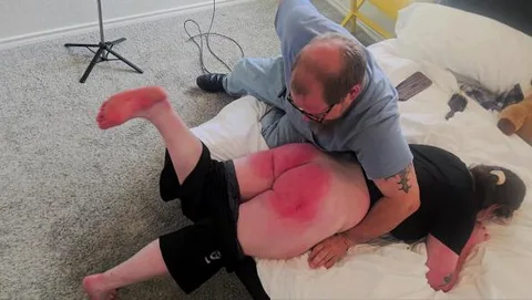 Kirsten spanked with a leather paddle
