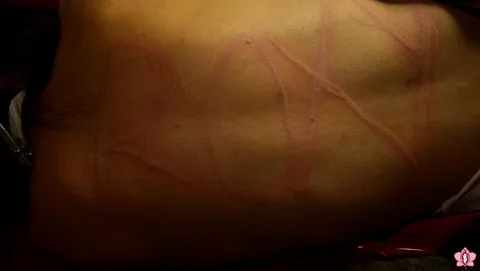 Mistress Roxy scratches her name into Milas back