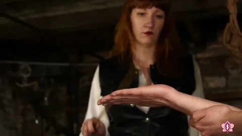 Slave Mila Endures 24 Cold-hearted Hand Caning Strokes from Mistress Roxy still 2